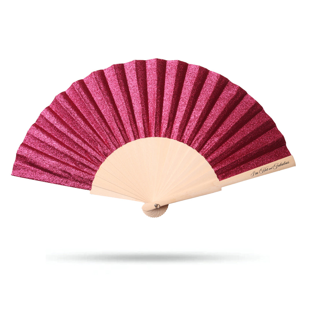 Pink glitter hand fan with beige handle on a white background
