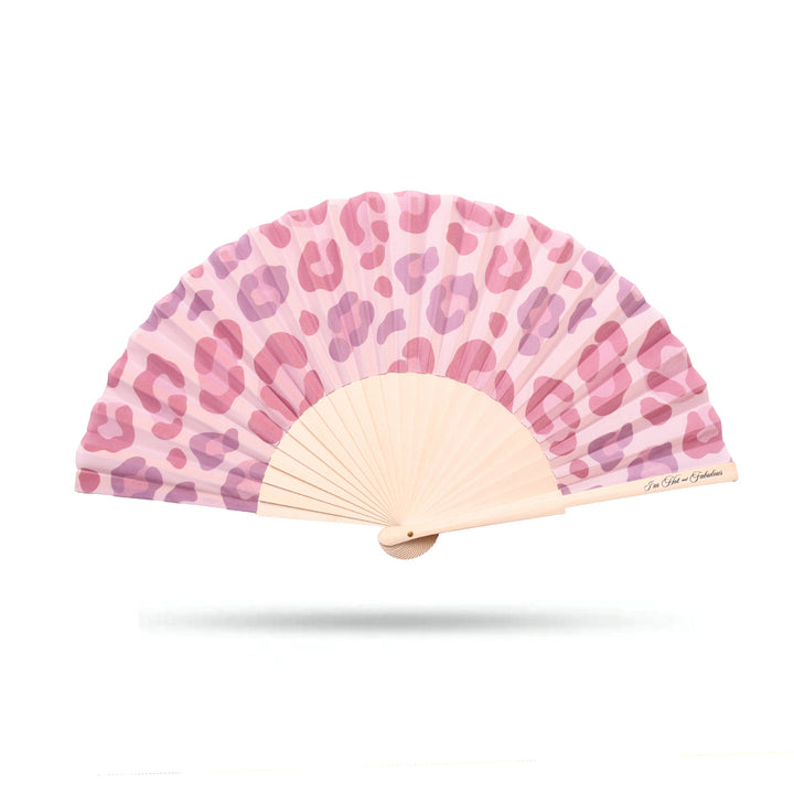 Handheld fan with pink leopard print design on a white background