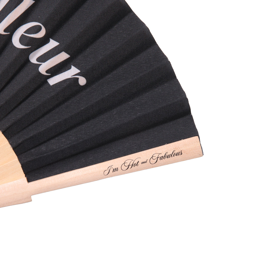 Black putain de chaleur hand fan with  'I'm Hot and Fabulous' text on a white background