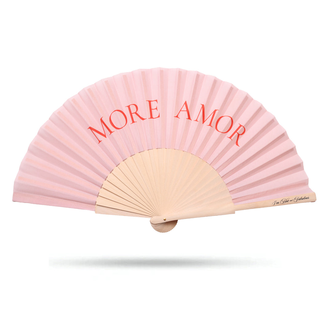 Pink hand fan with 'MORE AMOR' text on a white background