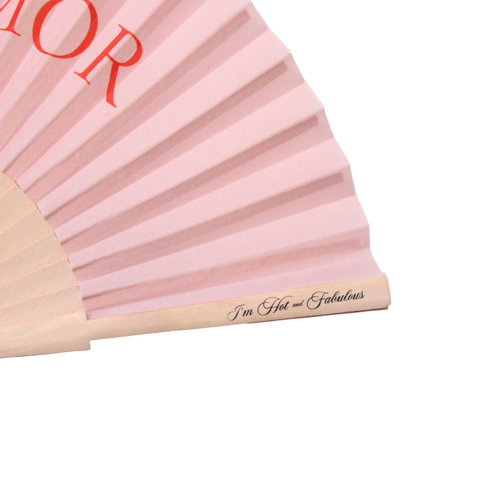 Pink folding fan with 'Hot and Fabulous' text on a white background