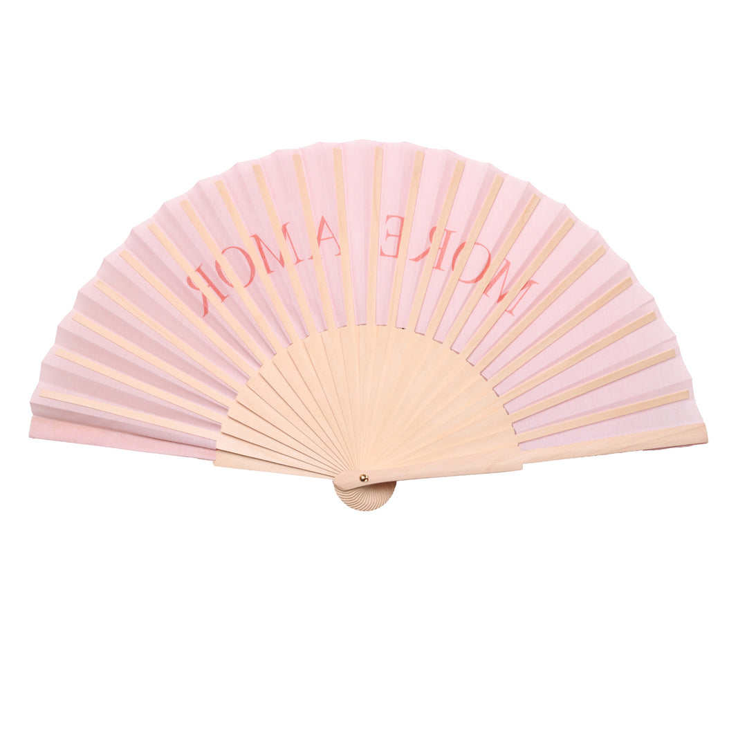 Pink hand fan with 'more amore' text on a white background