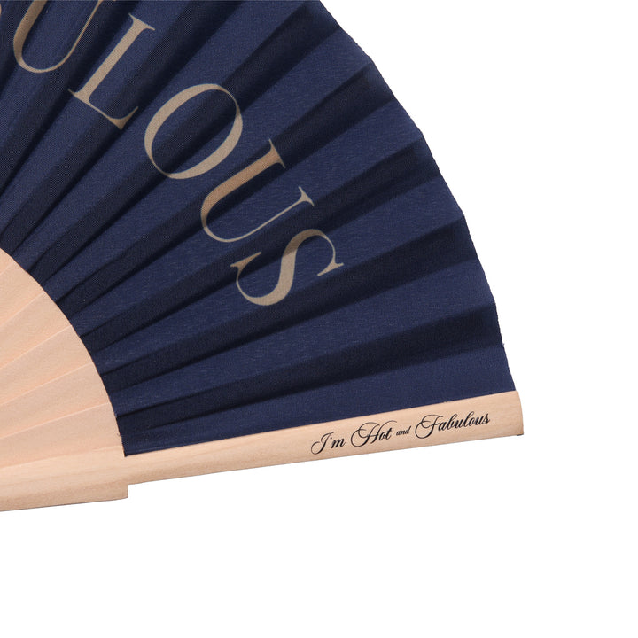 Navy blue fabric with gold text 'FABULOUS' and wooden handle on a white background