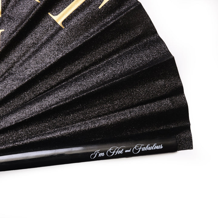 Black pleated fabric with gold lettering and 'I'm Hot and Fabulous' text on a white background