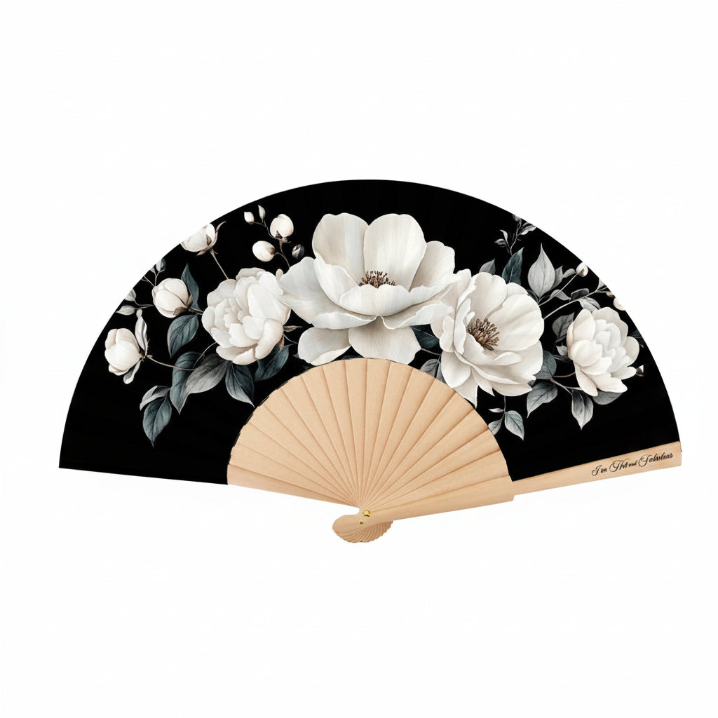 Handheld fan with floral design on a black background, featuring white flowers and beige wooden blades.