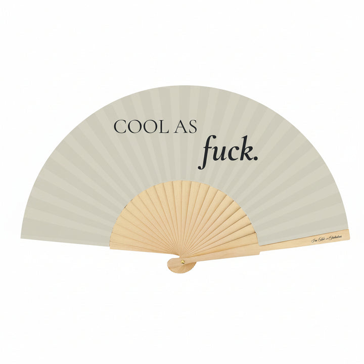 Handheld fan with text 'COOL AS fuck.' on a light gray background