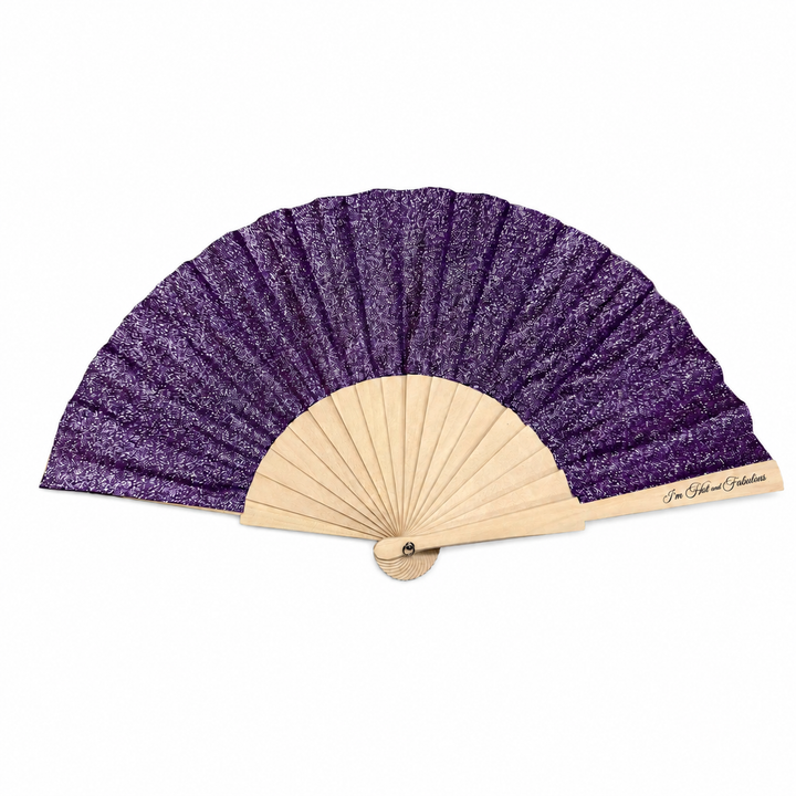 Purple and beige hand fan on a white background
