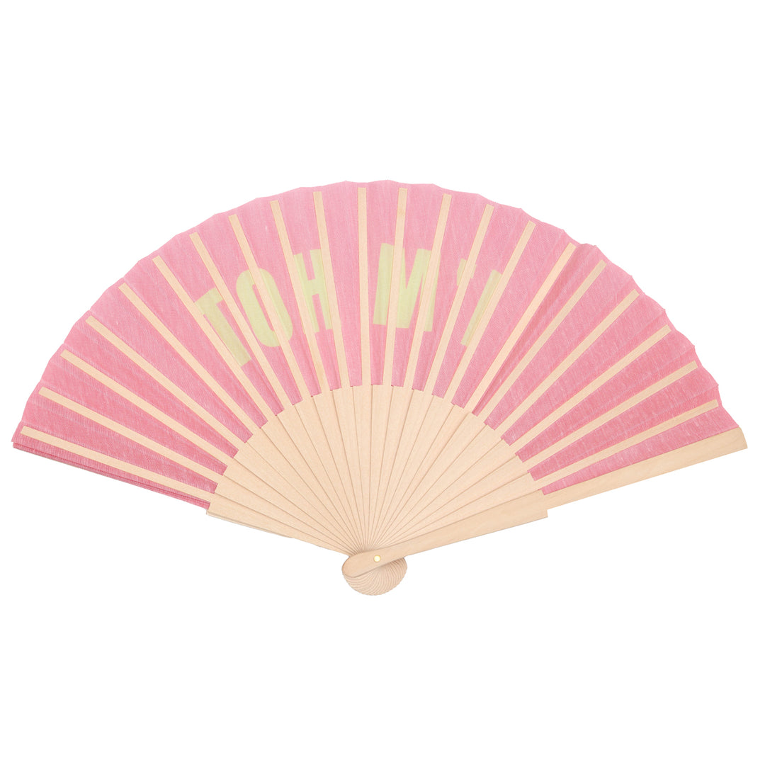 Pink hand fan with beige sticks on a white background