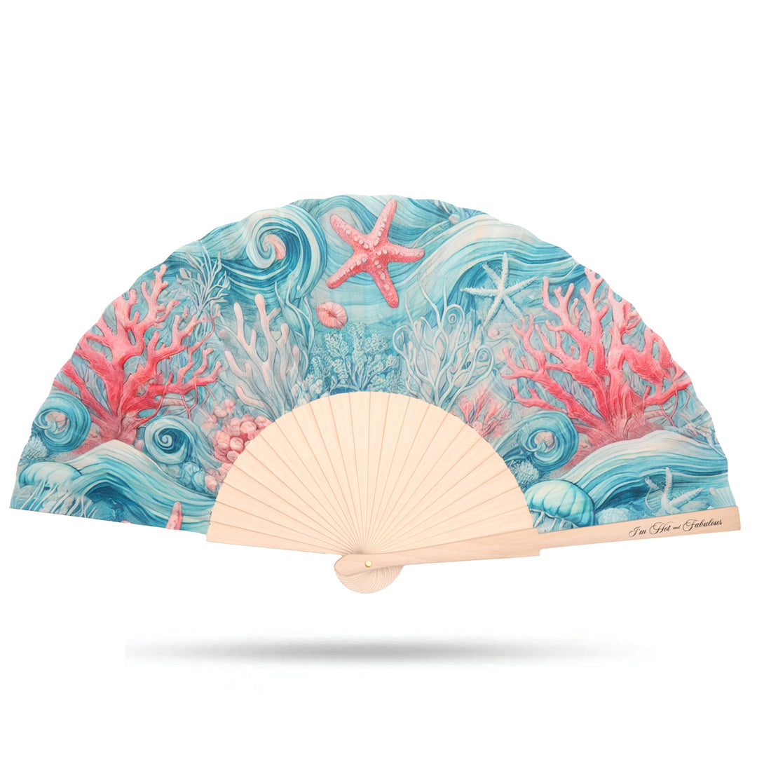 Handheld fan with ocean-themed design featuring coral and starfish on a white background