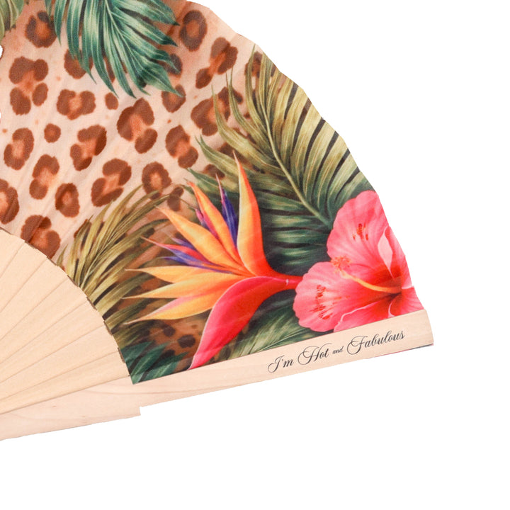 Handheld fan with tropical floral and leopard print design on a white background