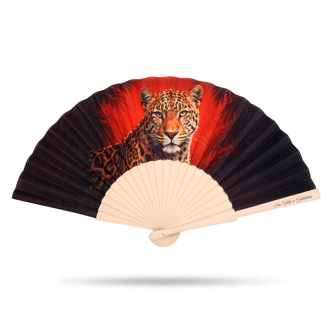 Hand fan with a leopard design on a red background