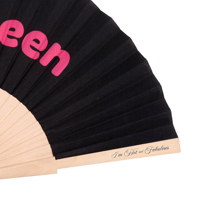 Black pleated fan with pink text and beige band on a white background