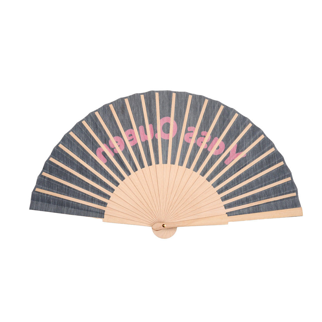 Handheld fan with yass queen design on a white background