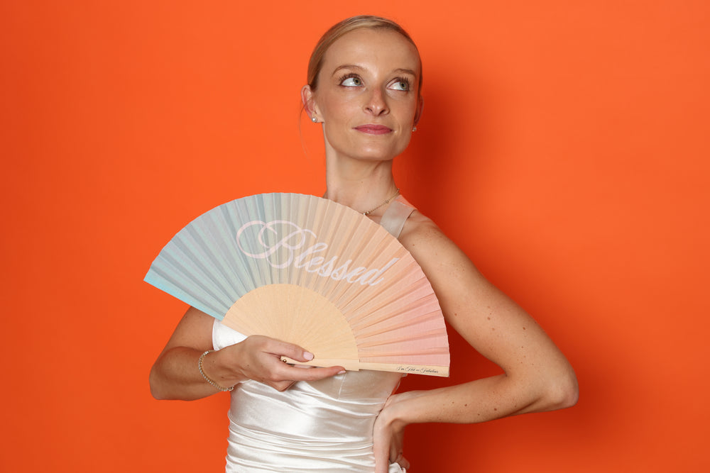 woman with blessed folding hand fan