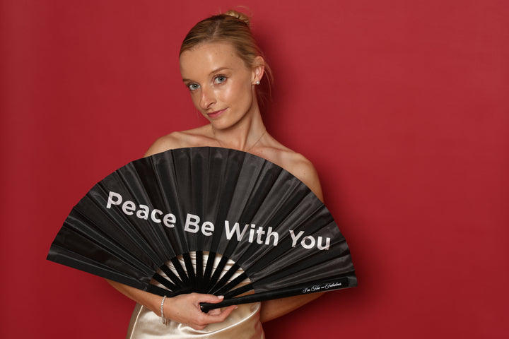 girl with fan that says peace be with you