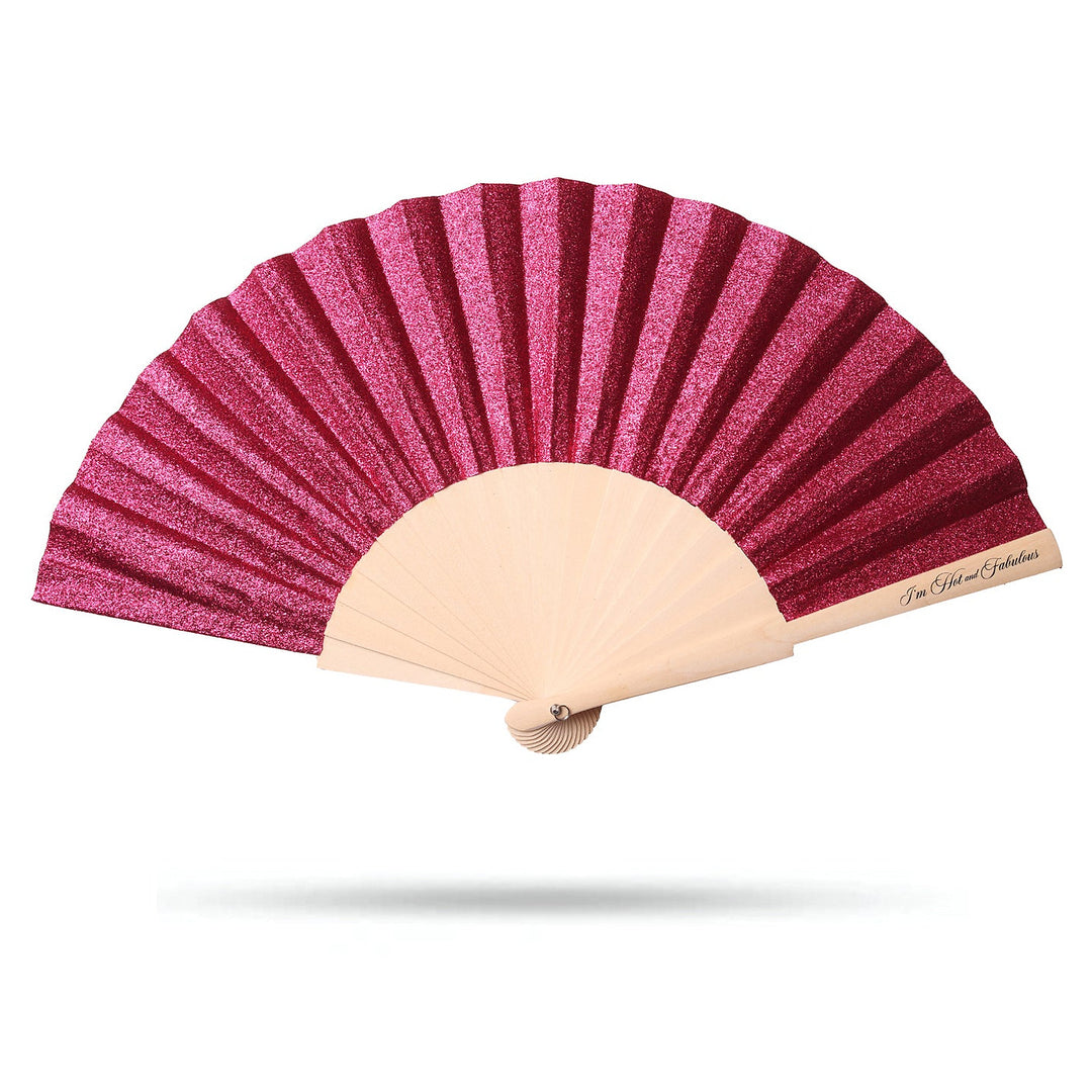 Pink glitter hand fan with beige handle on a white background