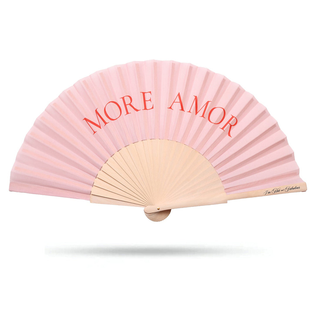 Pink hand fan with 'MORE AMOR' text on a white background