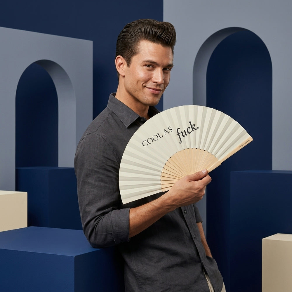 Man holding a fan with text against a geometric background