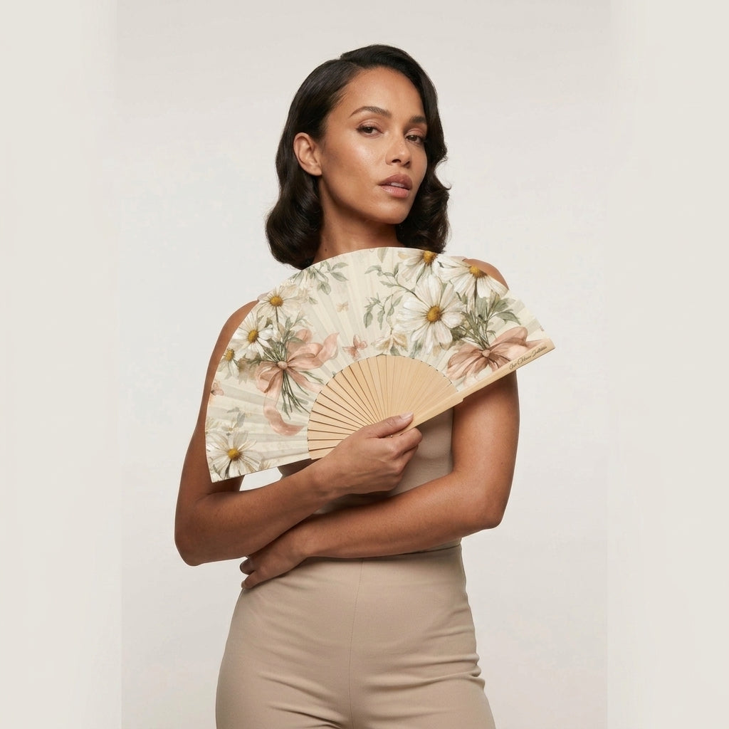 Woman holding a floral-patterned fan against a plain background