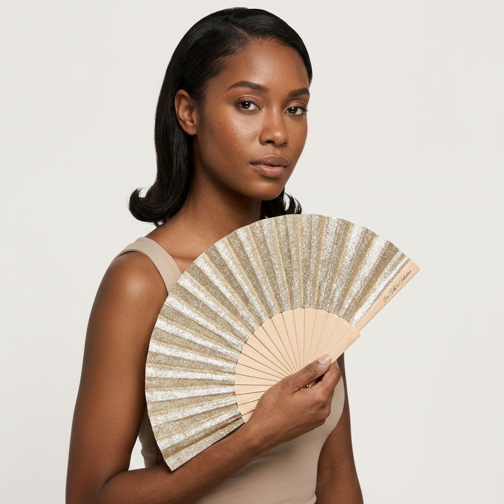 Woman holding a decorative fan against a plain background