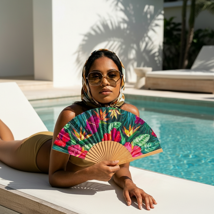 Woman holding a colorful fan by a poolside