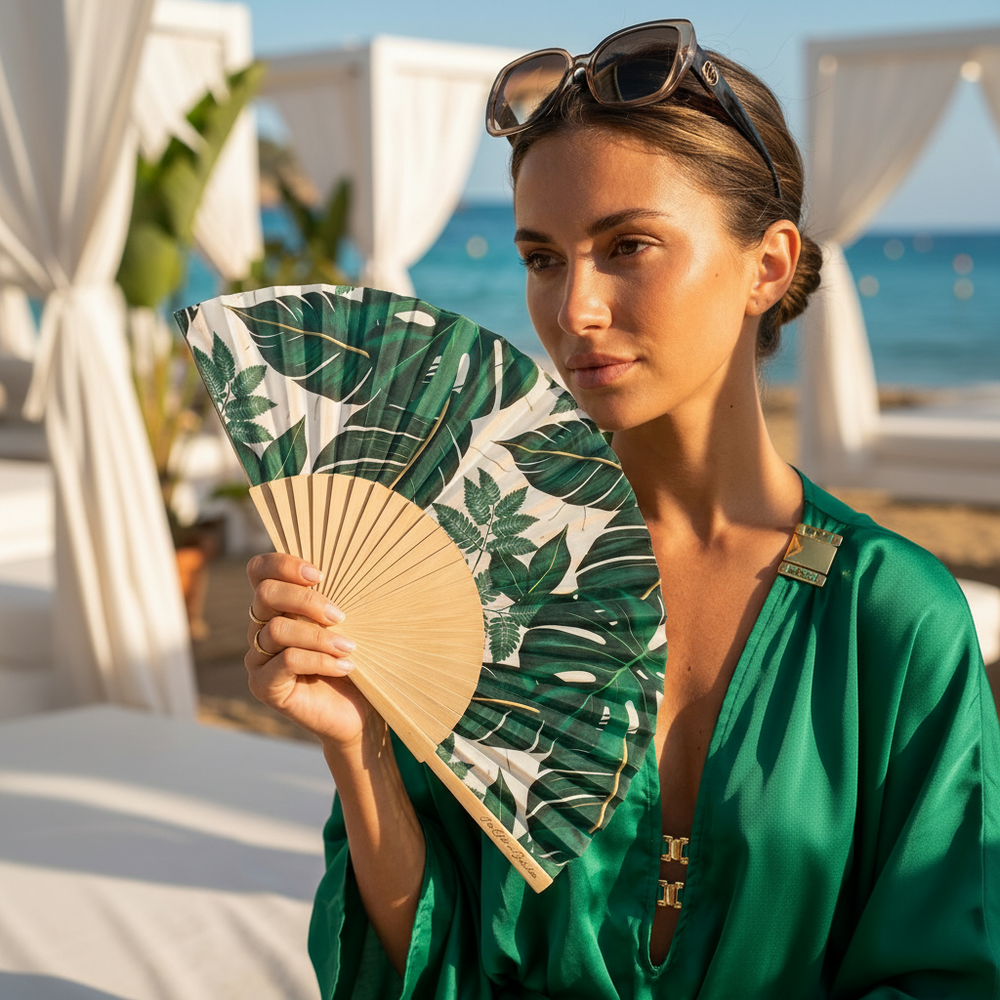 Woman holding a leaf-patterned fan with a scenic background