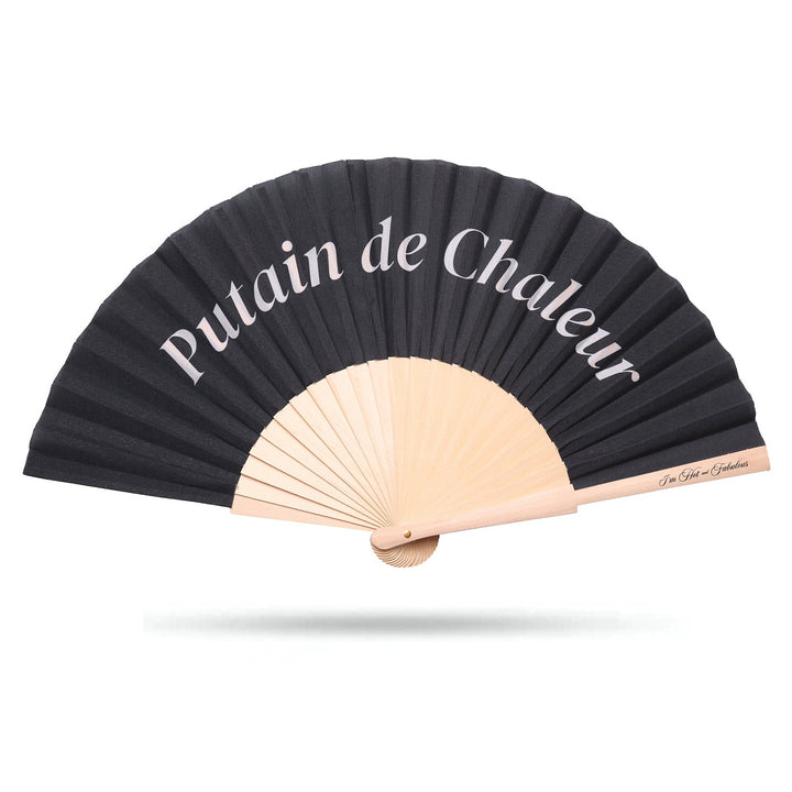 Black hand fan with beige sticks and 'Putain de Chaleur' text on a white background